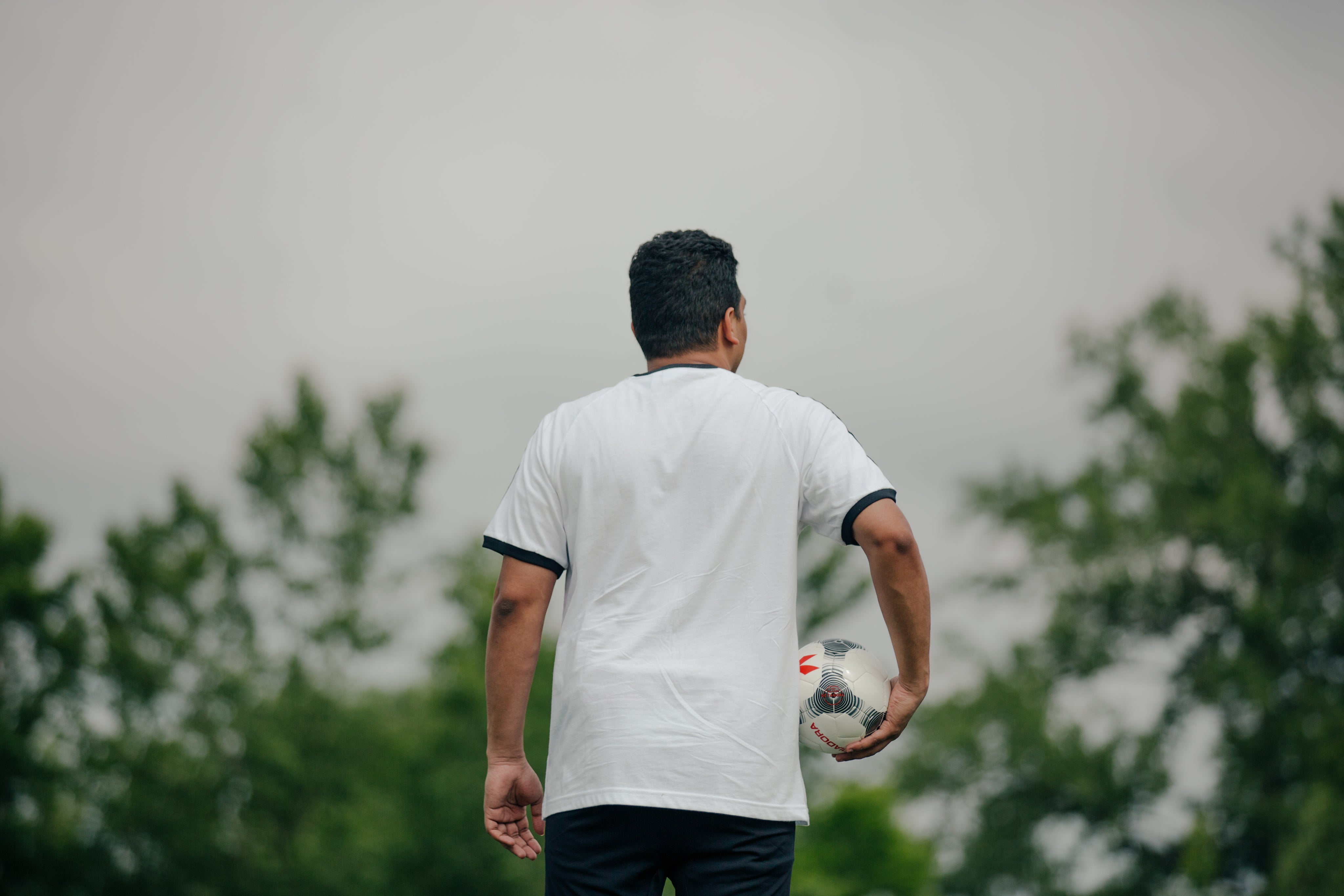 soccer-player-holding-ball-looking-out.jpg